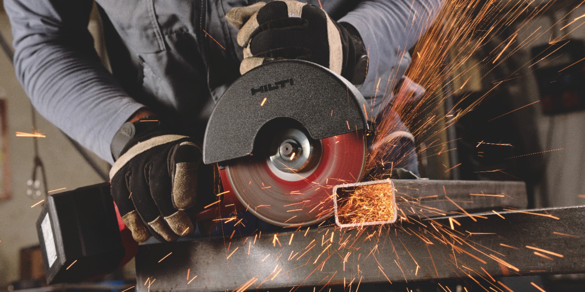 Construction worker using a AG 600-A36 Cordless angle grinder with Active Torque Control (ATC) to help prevent kickback